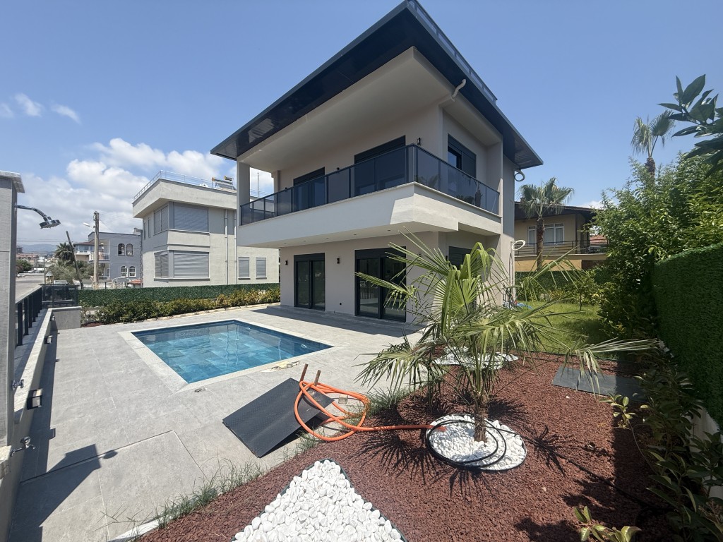 Modern two-story luxury villa with a private swimming pool, landscaped garden, and spacious outdoor living area.