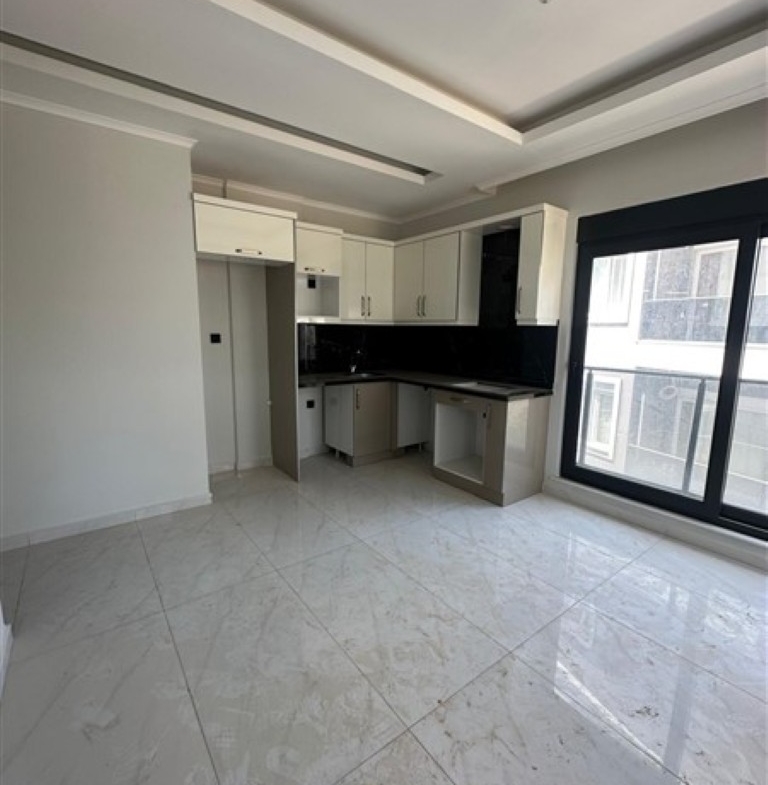 Modern kitchen cabinets and workspace in the United Suites apartment.