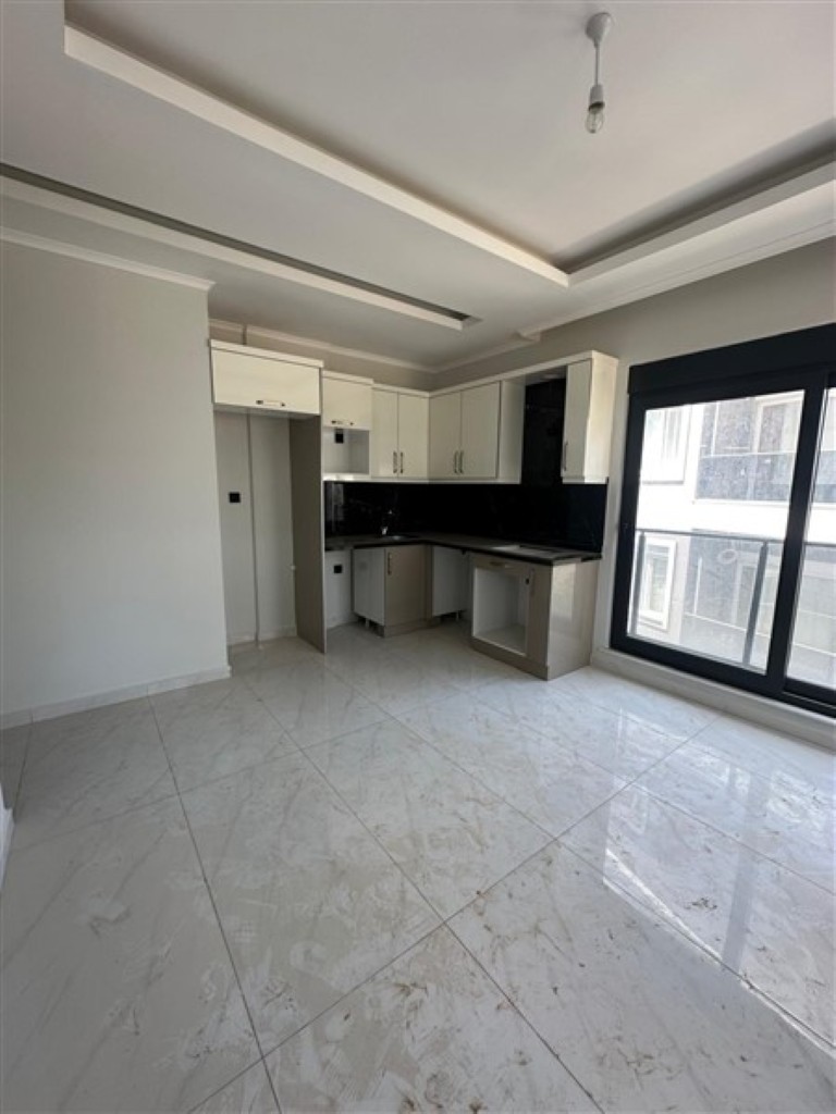Modern kitchen cabinets and workspace in the United Suites apartment.