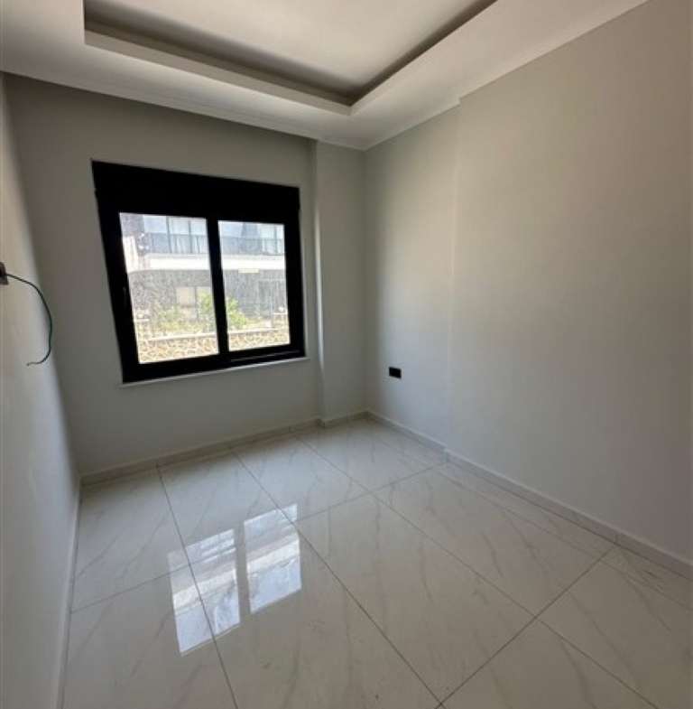 Bright and spacious living room of the 1+1 apartment in Oba.