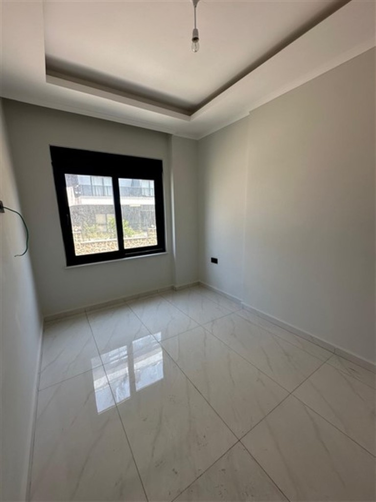 Bright and spacious living room of the 1+1 apartment in Oba.