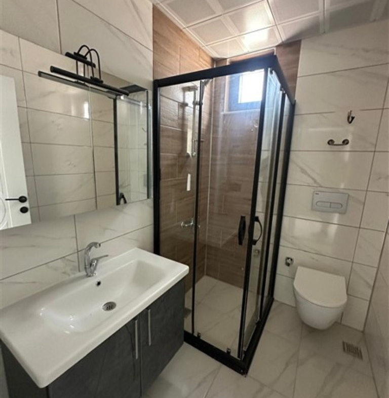 Modern bathroom featuring high-quality ceramic tiles and fixtures.