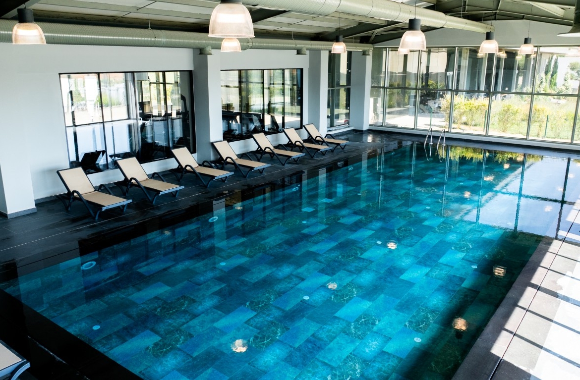 jpg displays the project's exclusive social facility, featuring a large heated indoor swimming pool with modern architectural details.
