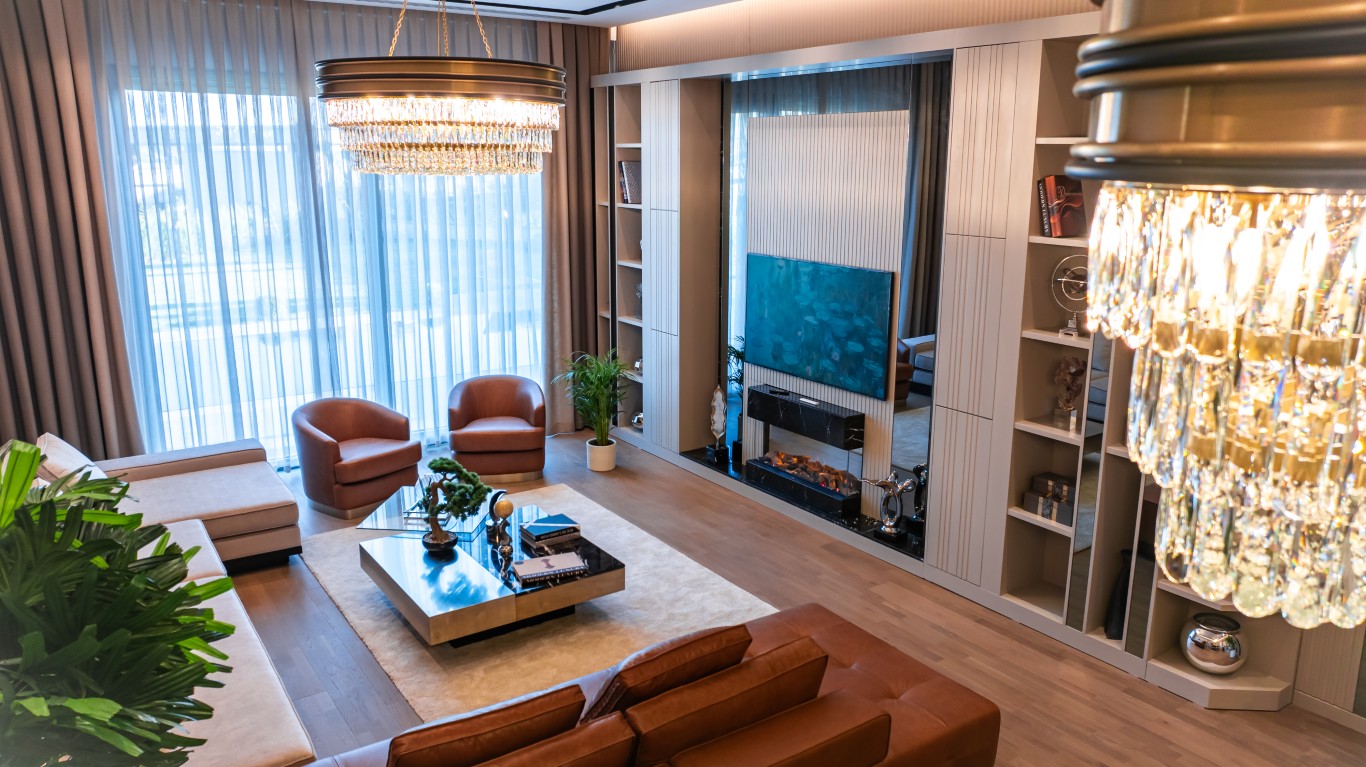 jpg, highlighting comfortable leather seating, a modern TV unit with a built-in fireplace, and chic decor.
