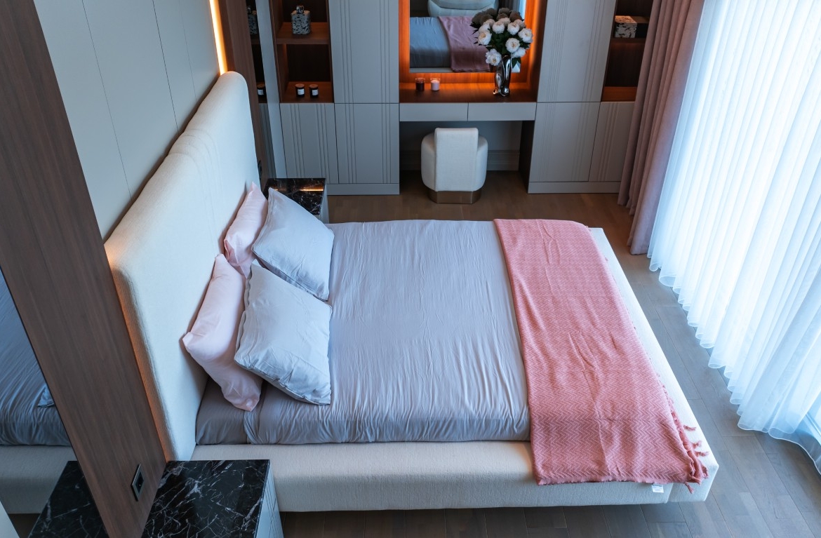 JPEG highlights a spacious master bedroom featuring modern built-in wardrobes, elegant lighting, and premium interior finishes.