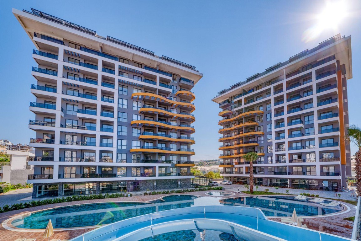Exterior view of modern residential blocks in Nobby Garden 1 featuring an outdoor swimming pool with water slide