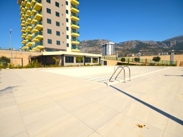 Outdoor swimming pool and modern residential building in Konak Garden Life 2 Alanya