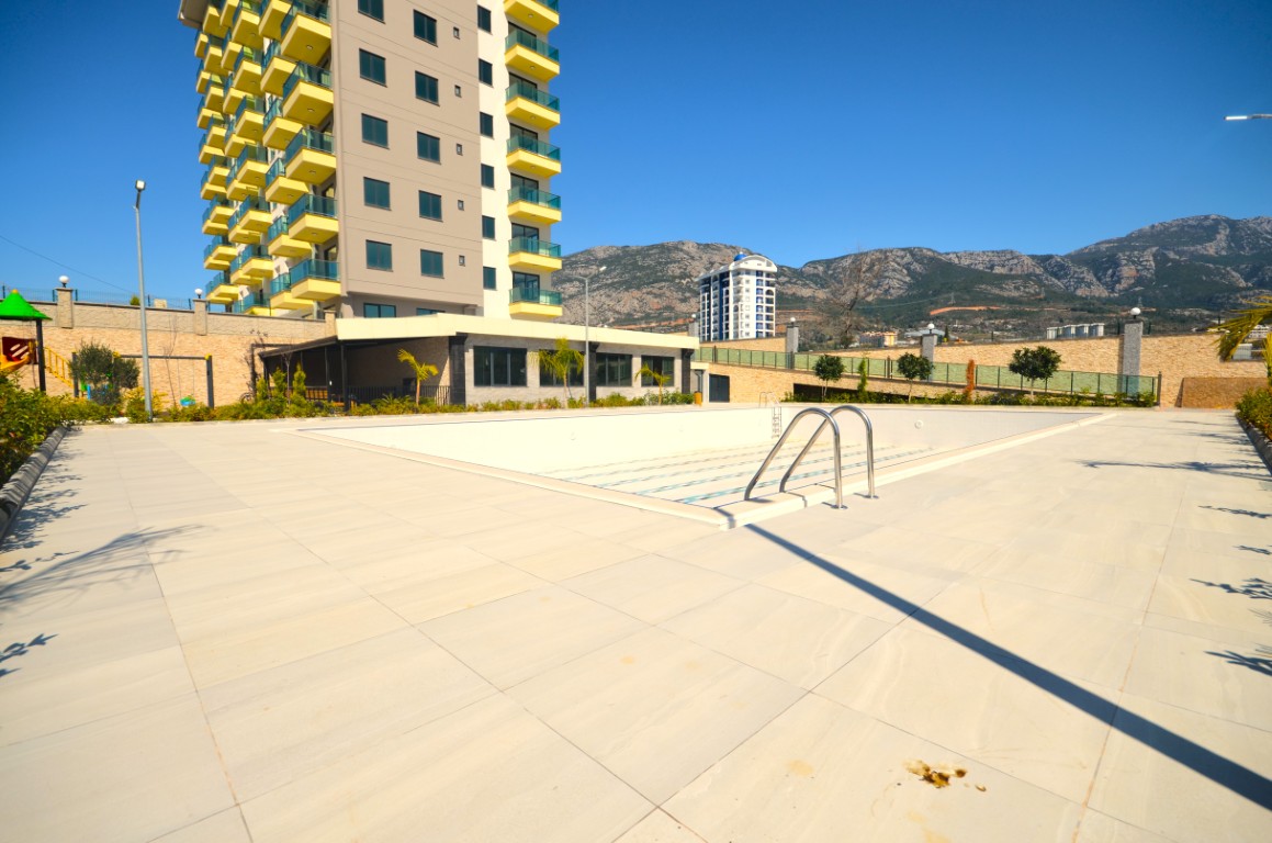 Outdoor swimming pool and modern residential building in Konak Garden Life 2 Alanya