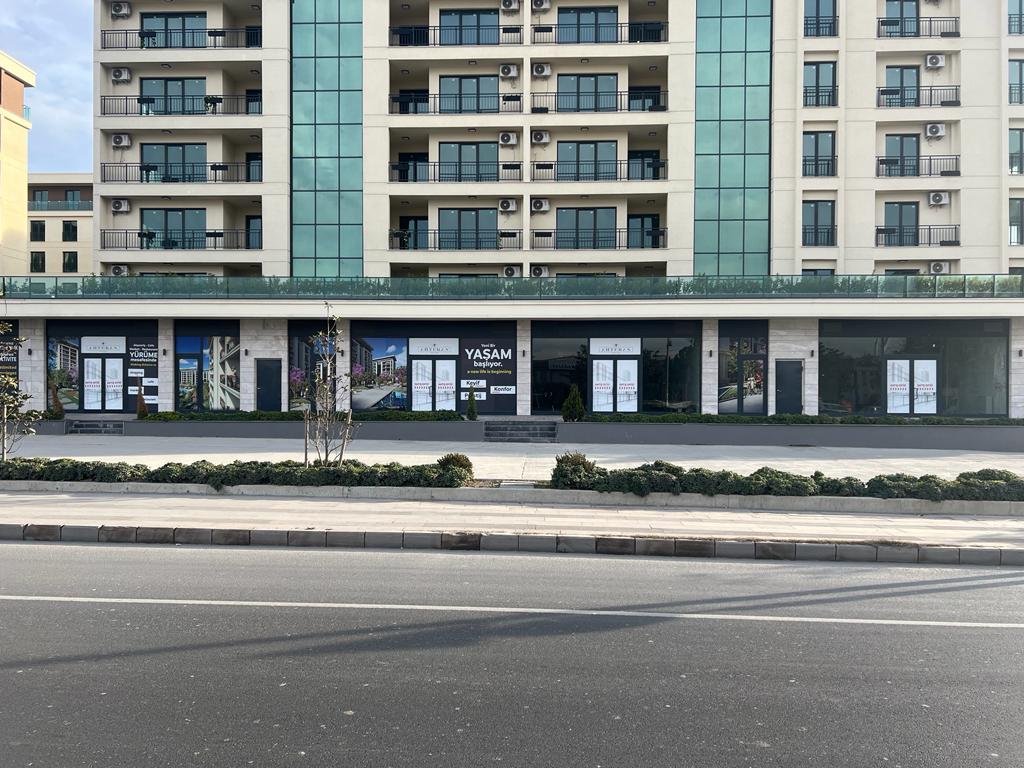 Street-level commercial retail spaces on the ground floor of a modern apartment building.