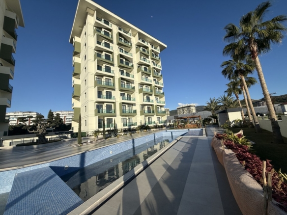 Exterior view and outdoor swimming pool of the Best Home 44 Gardenia complex featuring a 2 bedroom apartment for sale in Demirtas Alanya