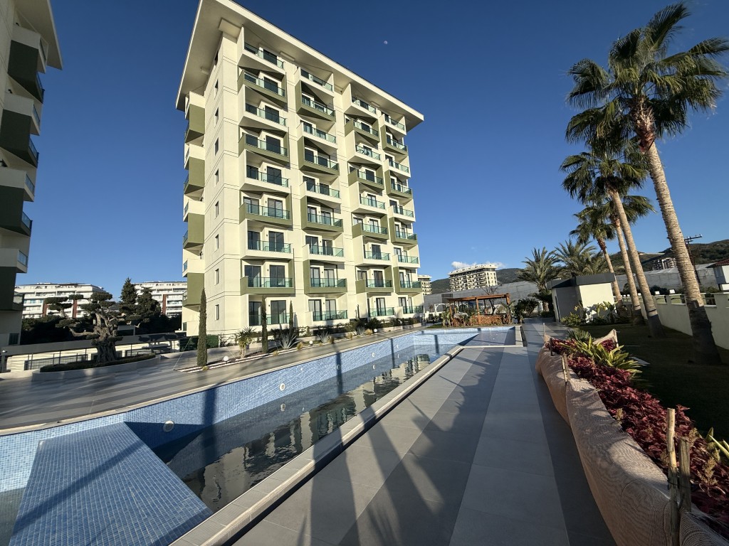 Exterior view and outdoor swimming pool of the Best Home 44 Gardenia complex featuring a 2 bedroom apartment for sale in Demirtas Alanya