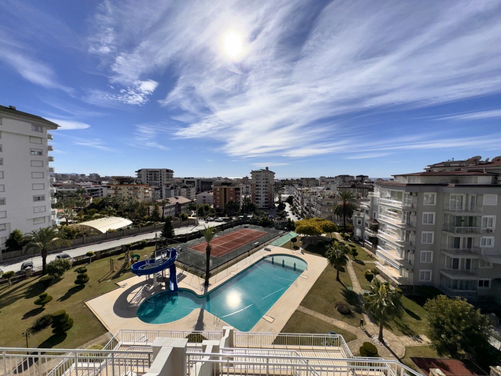 Panoramic view of the swimming pool and landscaped grounds at Hellios Residence, Cikcilli, Alanya