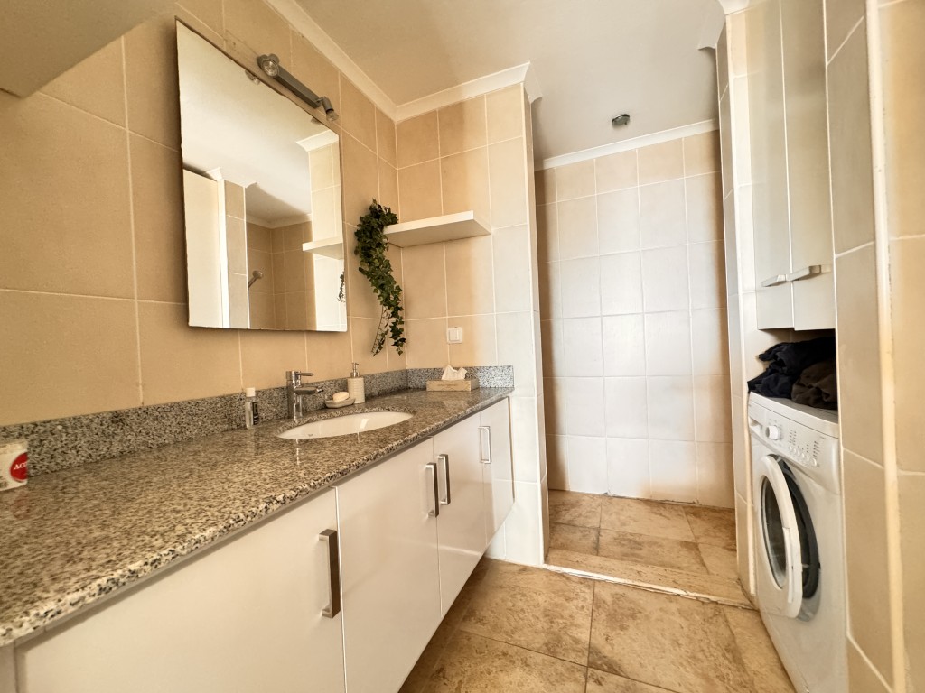 Second bathroom with vanity and washing machine in Hellios Residence, Cikcilli, Alanya