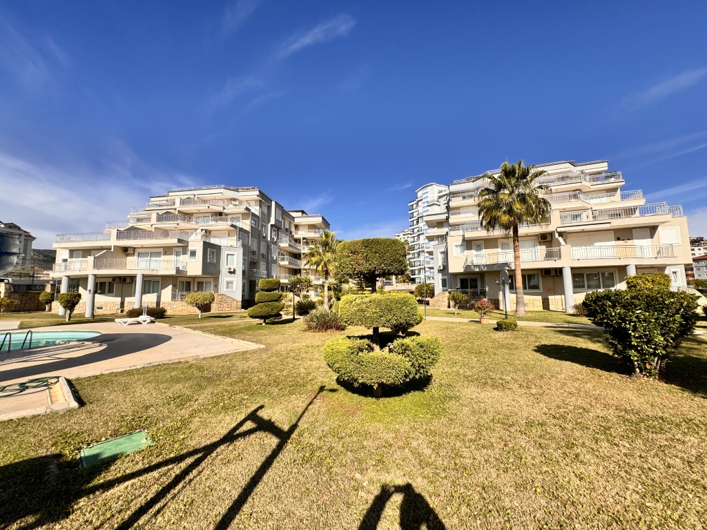 Landscaped gardens and residential buildings at Hellios Residence, Cikcilli, Alanya