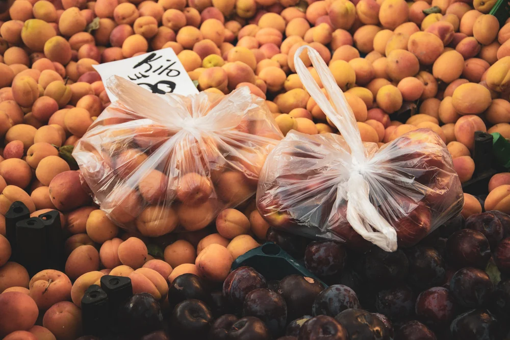 Apricots and plums at a market in Alanya · wider city context