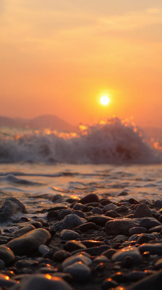 Pebbles and evening light · illustrative coastal photograph