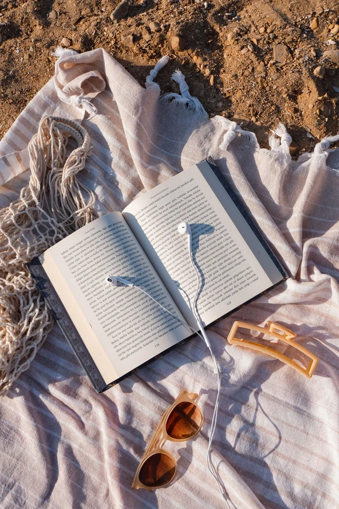 A book beside the sea · illustrative beach-day photograph