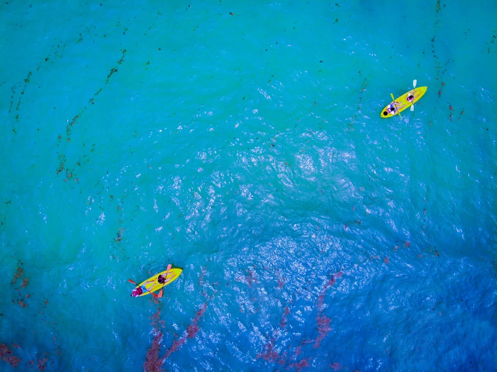 Kayaks on turquoise water · illustrative coastal activity photograph
