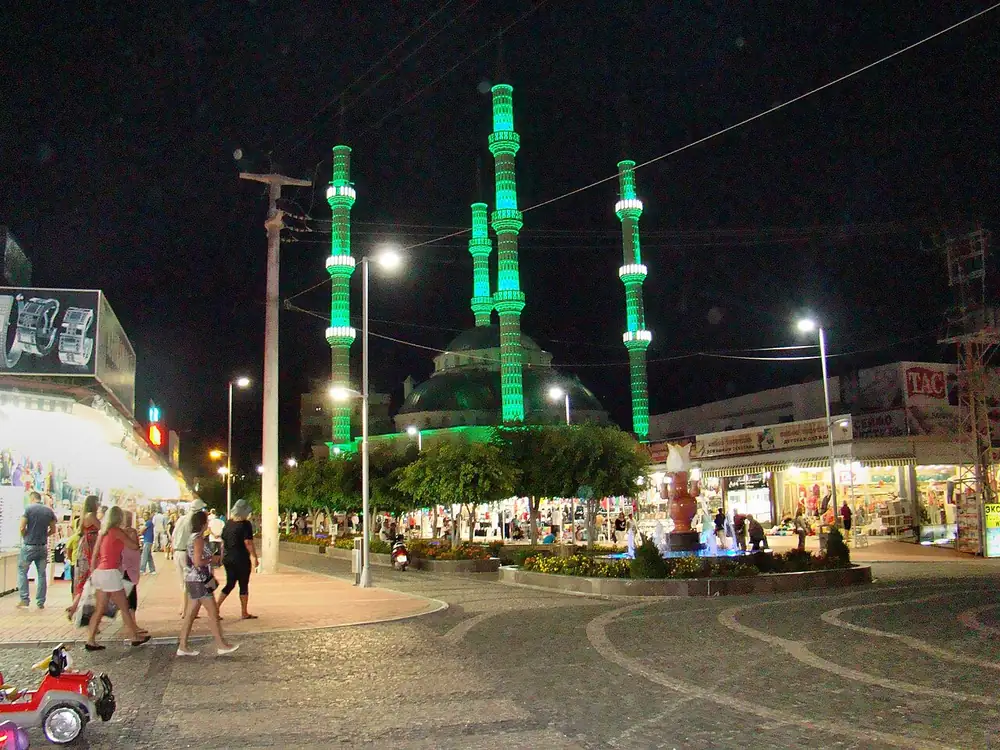Evening street life and the mosque in Konaklı · archive photograph, 2013